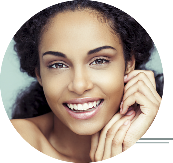 Close-up of a woman smiling and framing her face with her hands